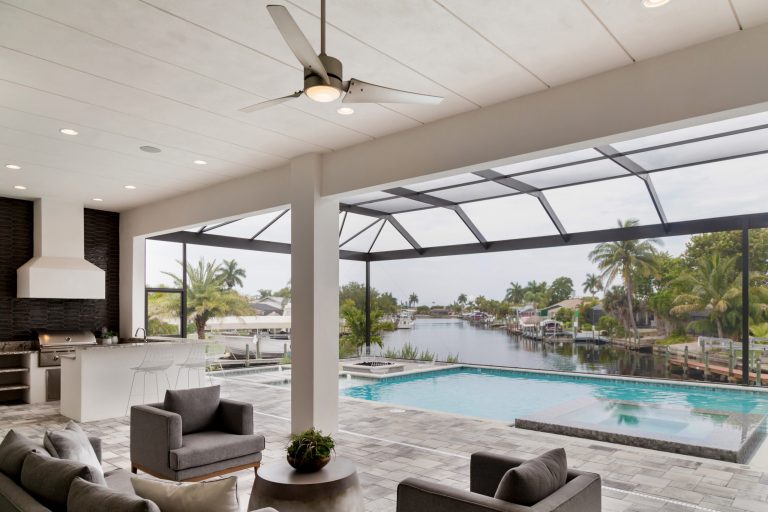 Inspiration for a large transitional backyard stone patio kitchen remodel in Miami with a roof extension