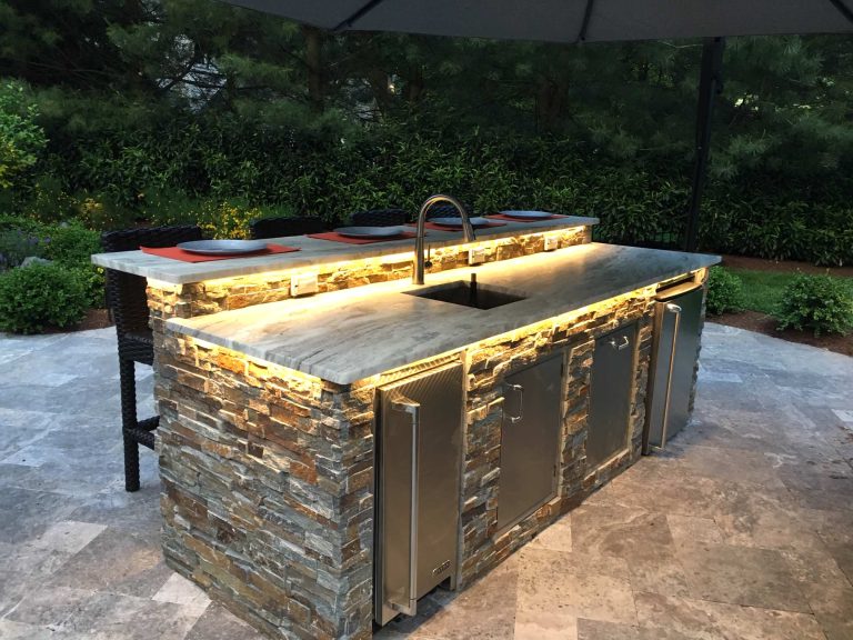 Inspiration for a large transitional backyard stone patio kitchen remodel in New York with no cover
