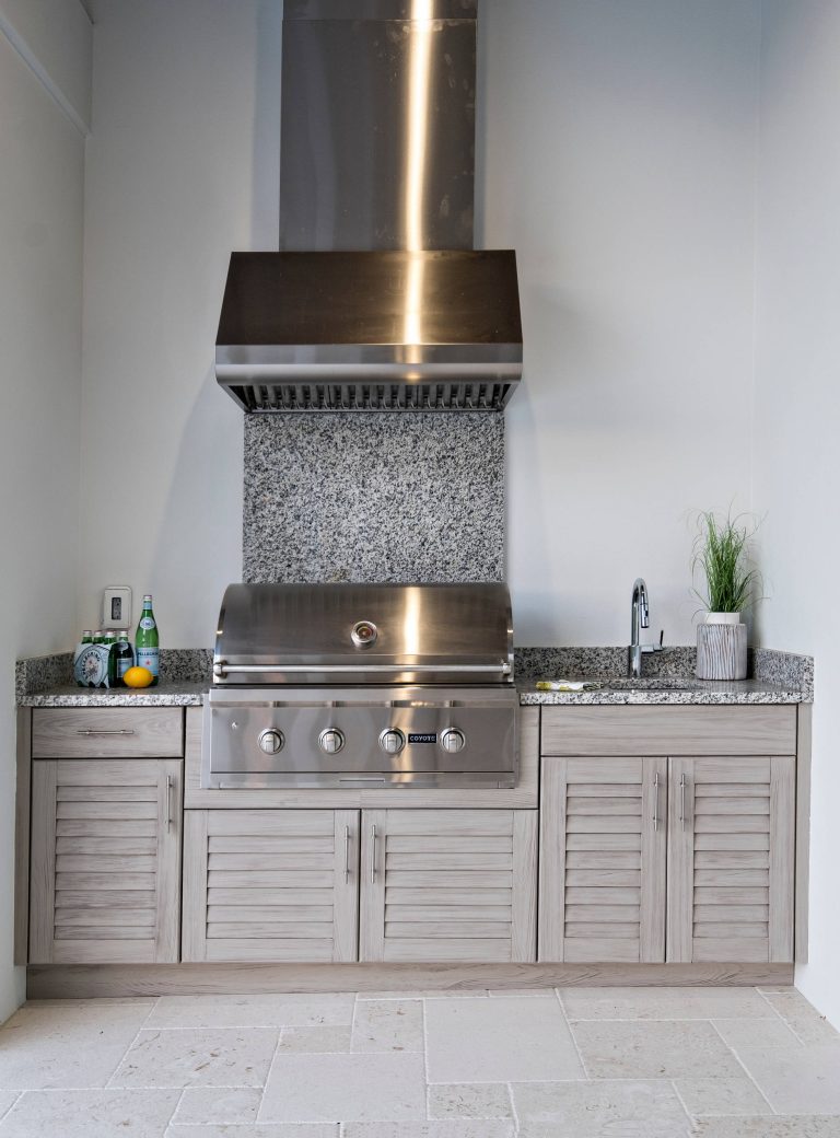 Inspiration for a large transitional backyard tile patio kitchen remodel in Miami with a roof extension
