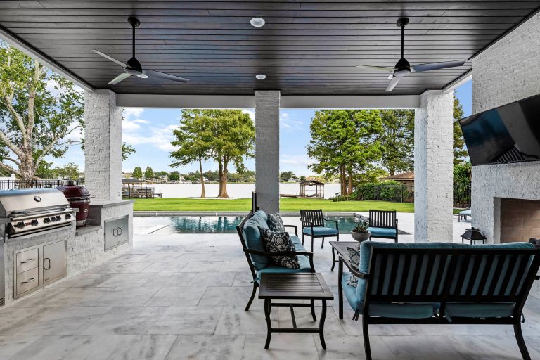 Inspiration for a large transitional backyard tile patio kitchen remodel in Orlando with a roof extension