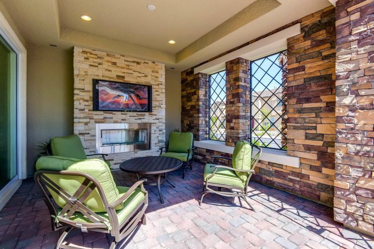 Inspiration for a large transitional brick front porch remodel in Las Vegas with a fire pit and a roof extension by Touchstone Living | Outdoor Photos | Porch | Landscaping | Landscape Design | Outdoor Living Space | Porch Design Ideas | Outdoor Living Space Ideas | Backyard Design