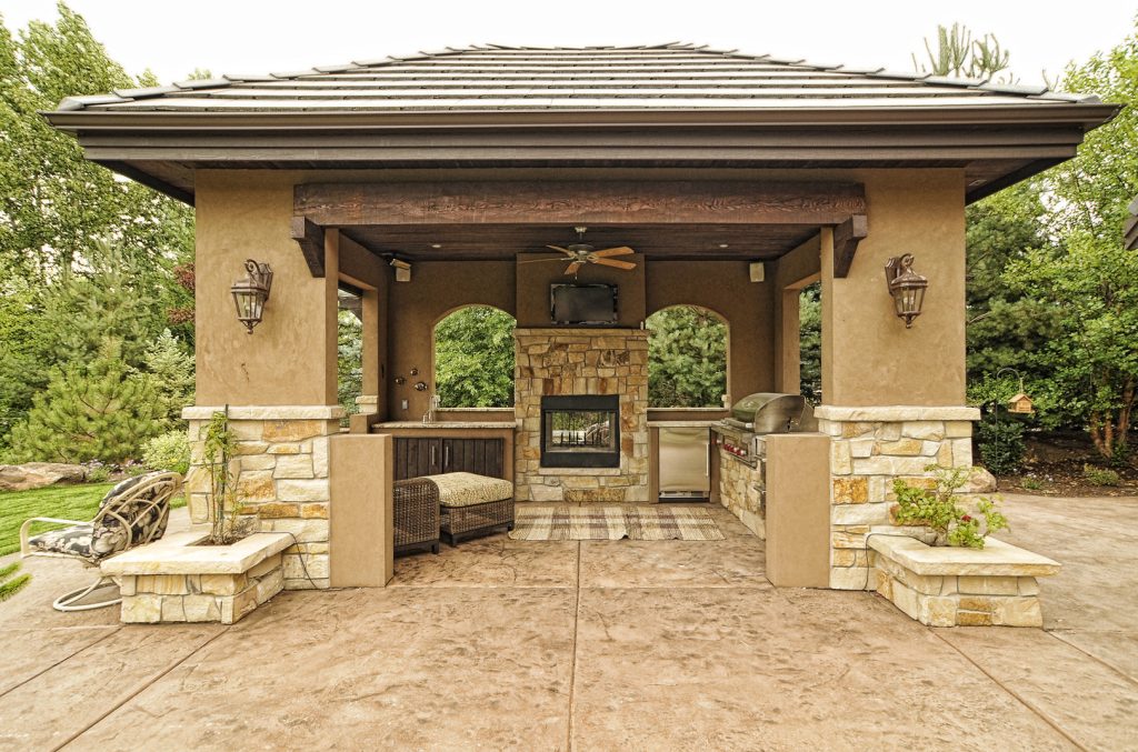 Inspiration for a large transitional stamped concrete back porch remodel in Boise with a fire pit and a roof extension by Paradigm Construction Company | Outdoor Photos | Porch | Landscaping | Landscape Design | Outdoor Living Space | Porch Design Ideas | Outdoor Living Space Ideas | Backyard Design