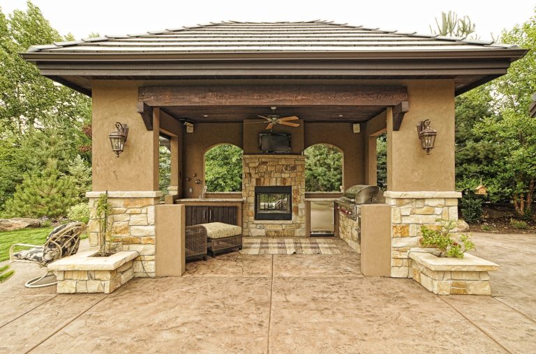 Inspiration for a large transitional stamped concrete back porch remodel in Boise with a fire pit and a roof extension by Paradigm Construction Company | Outdoor Photos | Porch | Landscaping | Landscape Design | Outdoor Living Space | Porch Design Ideas | Outdoor Living Space Ideas | Backyard Design