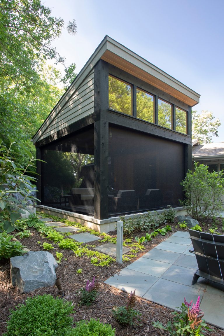 Inspiration for a large transitional stone screened-in back porch remodel in Minneapolis with a roof extension by TreHus Architects+Interior Designers+Builders | Outdoor Photos | Porch | Landscaping | Landscape Design | Outdoor Living Space | Porch Design Ideas | Outdoor Living Space Ideas | Backyard Design