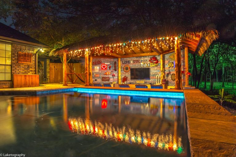 Inspiration for a large tropical backyard custom-shaped lap hot tub remodel in Orange County