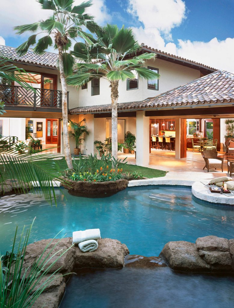 Inspiration for a large tropical backyard stone and custom-shaped natural hot tub remodel in Hawaii