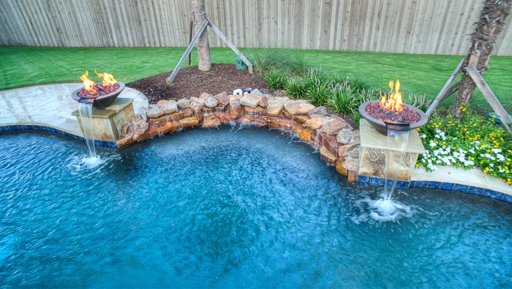 Inspiration for a large tropical backyard tile and kidney-shaped hot tub remodel in Dallas