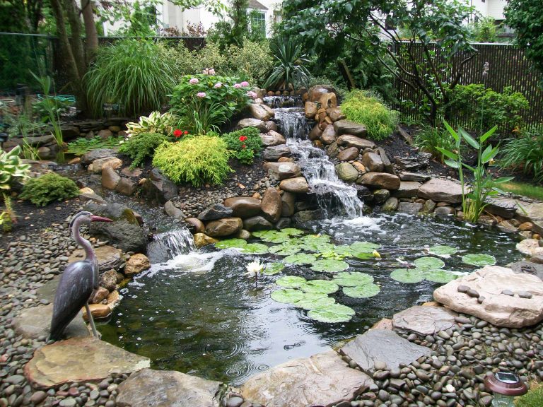 Inspiration for a large tropical partial sun backyard pond in New York.