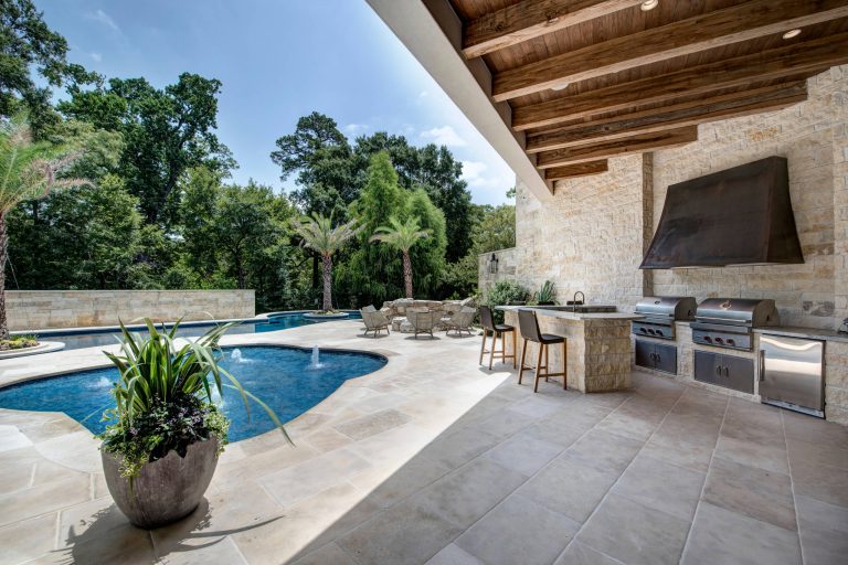 Inspiration for a mediterranean backyard tile patio kitchen remodel in Houston with a roof extension