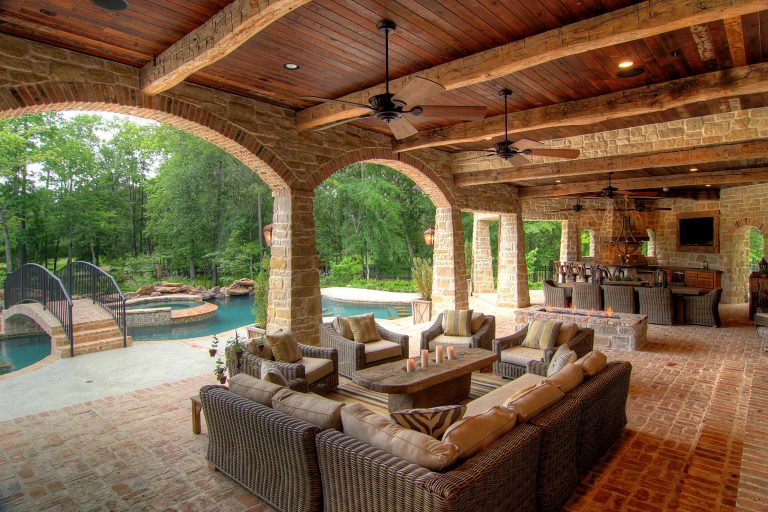 Inspiration for a mediterranean brick porch remodel in Houston with a fire pit and a roof extension by Eklektik Interiors | Outdoor Photos | Porch | Landscaping | Landscape Design | Outdoor Living Space | Porch Design Ideas | Outdoor Living Space Ideas | Backyard Design