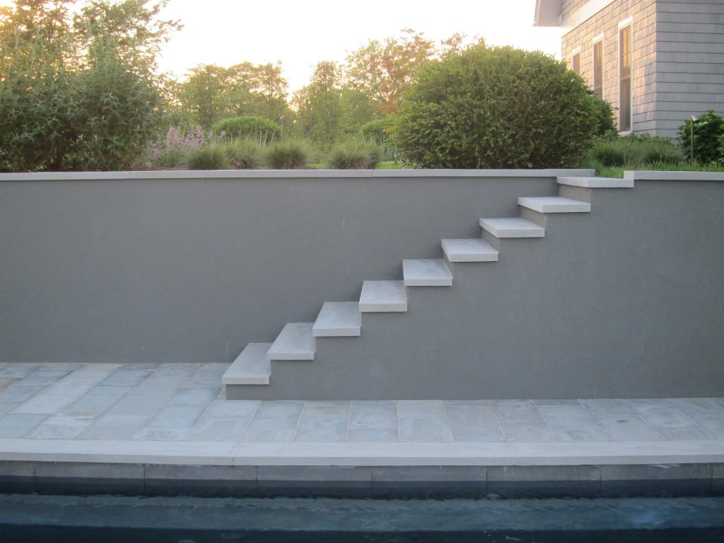 Inspiration for a mid-sized asian backyard stone and rectangular pool remodel in New York