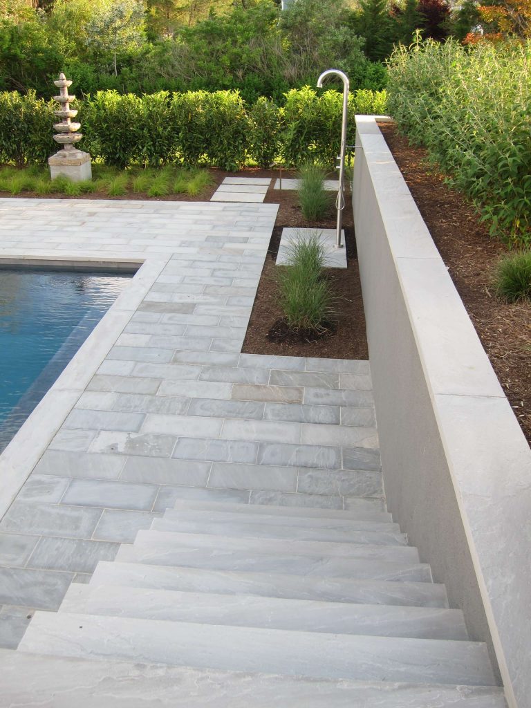 Inspiration for a mid-sized asian backyard stone and rectangular pool remodel in New York