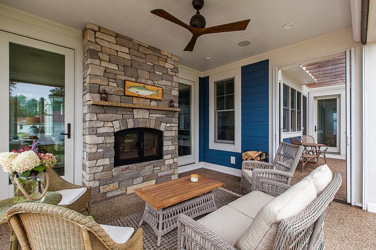 Inspiration for a mid-sized coastal porch remodel in Grand Rapids with a roof extension and a fireplace by Visbeen Architects | Outdoor Photos | Porch | Landscaping | Landscape Design | Outdoor Living Space | Porch Design Ideas | Outdoor Living Space Ideas | Backyard Design