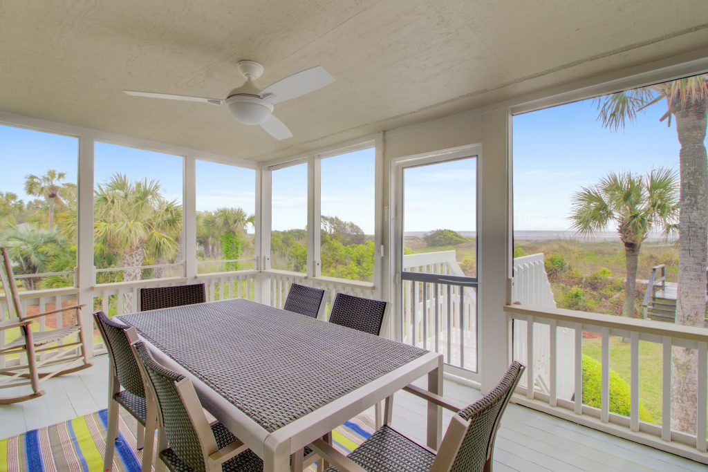 Inspiration for a mid-sized coastal screened-in back porch remodel in Charleston with decking and a roof extension by Lowcountry Contractors | Outdoor Photos | Porch | Landscaping | Landscape Design | Outdoor Living Space | Porch Design Ideas | Outdoor Living Space Ideas | Backyard Design