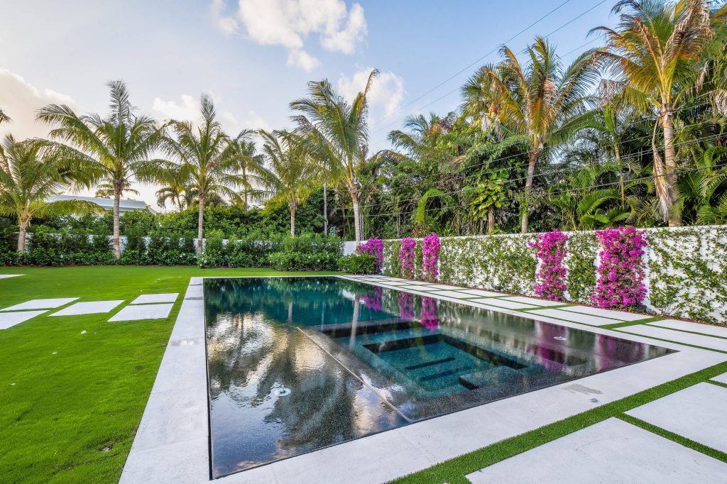 Inspiration for a mid-sized contemporary backyard concrete and rectangular lap hot tub remodel in Miami