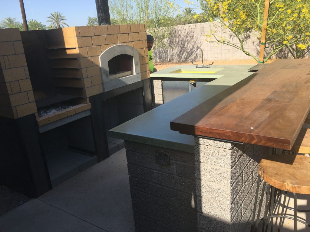 Inspiration for a mid-sized contemporary backyard concrete patio kitchen remodel in Phoenix with a pergola