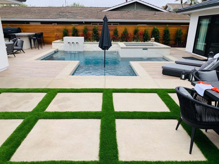 Inspiration for a mid-sized contemporary backyard concrete paver and custom-shaped pool fountain remodel in Orange County