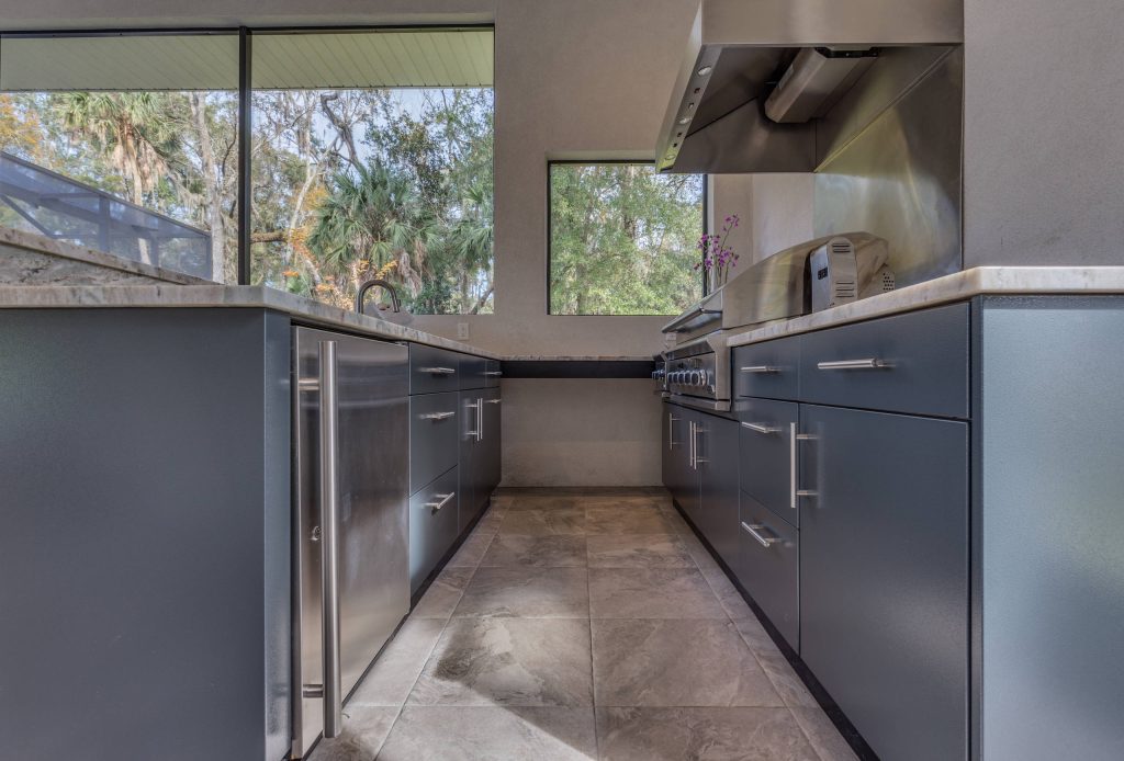 Inspiration for a mid-sized contemporary backyard concrete paver patio kitchen remodel in Jacksonville with a gazebo