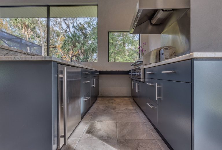 Inspiration for a mid-sized contemporary backyard concrete paver patio kitchen remodel in Jacksonville with a gazebo