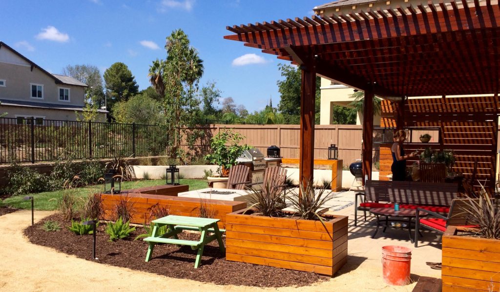 Inspiration for a mid-sized contemporary backyard concrete paver patio kitchen remodel in San Diego with a pergola