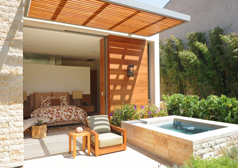 Inspiration for a mid-sized contemporary backyard stone and rectangular aboveground hot tub remodel in Los Angeles