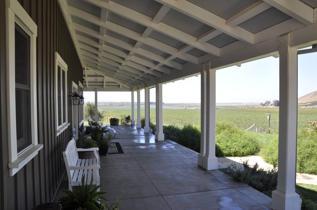 Inspiration for a mid-sized cottage concrete porch remodel in Santa Barbara with a roof extension by Dennis Thompson Architect | Outdoor Photos | Porch | Landscaping | Landscape Design | Outdoor Living Space | Porch Design Ideas | Outdoor Living Space Ideas | Backyard Design