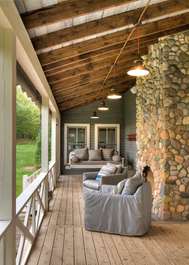 Inspiration for a mid-sized cottage front porch remodel in Minneapolis with a fire pit, decking and a roof extension by Lands End Development - Designers & Builders | Outdoor Photos | Porch | Landscaping | Landscape Design | Outdoor Living Space | Porch Design Ideas | Outdoor Living Space Ideas | Backyard Design