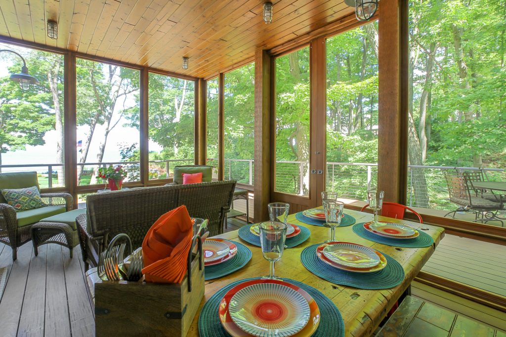 Inspiration for a mid-sized cottage screened-in back porch remodel in Grand Rapids with decking and a roof extension by Cottage Home, Inc. | Outdoor Photos | Porch | Landscaping | Landscape Design | Outdoor Living Space | Porch Design Ideas | Outdoor Living Space Ideas | Backyard Design