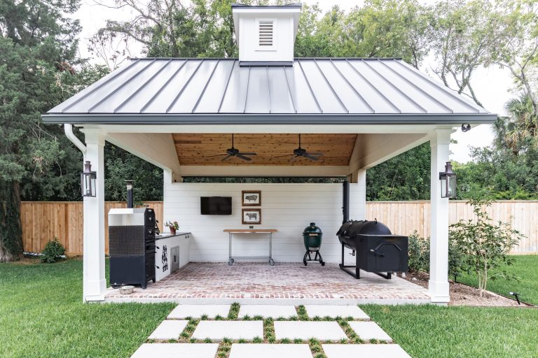 Inspiration for a mid-sized country backyard brick patio kitchen remodel in Houston with a gazebo