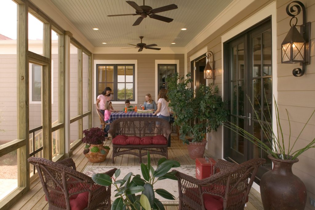 Inspiration for a mid-sized country screened-in back porch remodel in Nashville with decking and a roof extension by Looney Ricks Kiss | Outdoor Photos | Porch | Landscaping | Landscape Design | Outdoor Living Space | Porch Design Ideas | Outdoor Living Space Ideas | Backyard Design