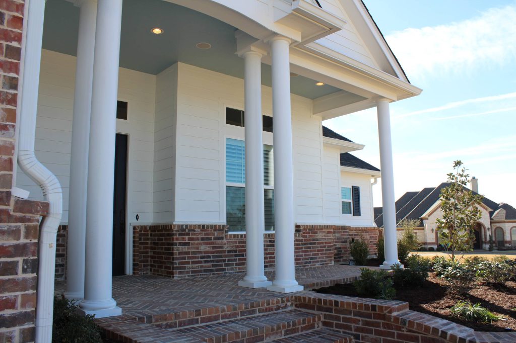 Inspiration for a mid-sized craftsman brick front porch remodel with a roof extension by Russ Davis Homes | Outdoor Photos | Porch | Landscaping | Landscape Design | Outdoor Living Space | Porch Design Ideas | Outdoor Living Space Ideas | Backyard Design