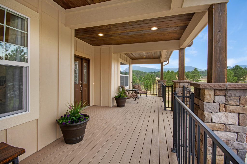 Inspiration for a mid-sized craftsman front porch remodel in Denver with decking and a roof extension by MasterBilt Homes, Inc. | Outdoor Photos | Porch | Landscaping | Landscape Design | Outdoor Living Space | Porch Design Ideas | Outdoor Living Space Ideas | Backyard Design