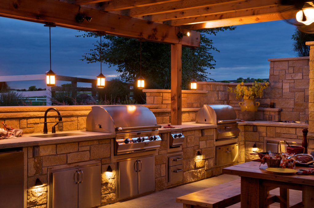 Inspiration for a mid-sized farmhouse backyard concrete patio kitchen remodel in Kansas City with a pergola