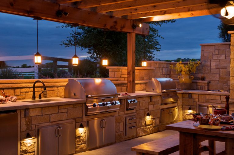 Inspiration for a mid-sized farmhouse backyard concrete patio kitchen remodel in Kansas City with a pergola