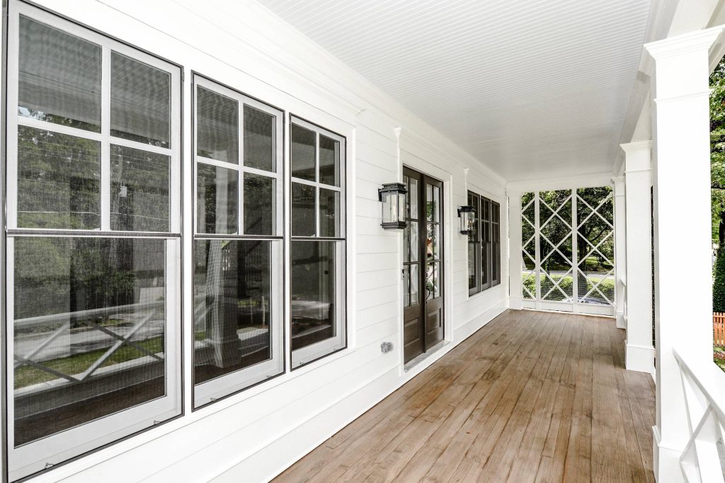 Inspiration for a mid-sized farmhouse front porch remodel in Atlanta with a roof extension, a fire pit and decking by Waterford Homes | Outdoor Photos | Porch | Landscaping | Landscape Design | Outdoor Living Space | Porch Design Ideas | Outdoor Living Space Ideas | Backyard Design