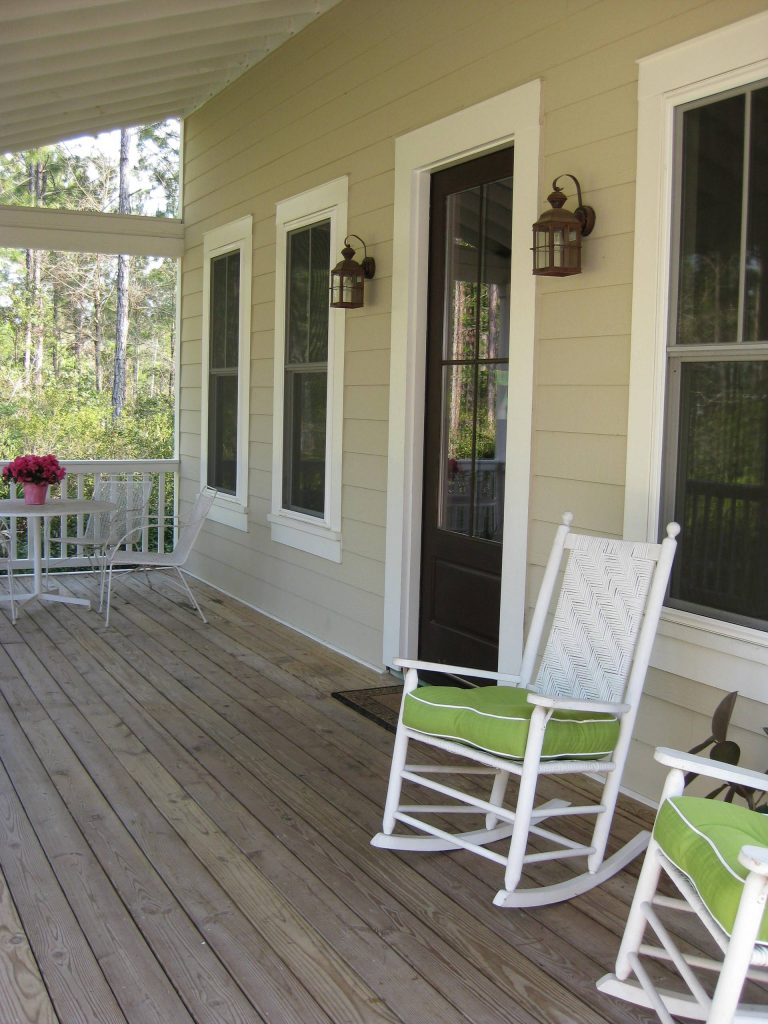 Inspiration for a mid-sized farmhouse front porch remodel in Jacksonville with decking and a roof extension by Coastal Cottage Builders, LLC | Outdoor Photos | Porch | Landscaping | Landscape Design | Outdoor Living Space | Porch Design Ideas | Outdoor Living Space Ideas | Backyard Design