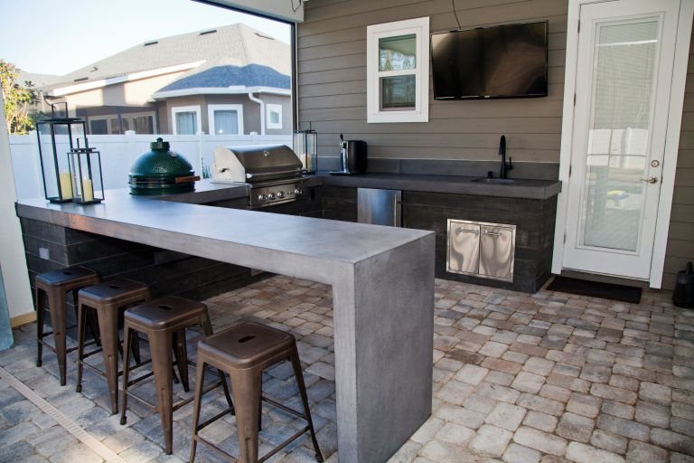 Inspiration for a mid-sized modern backyard brick patio kitchen remodel in Jacksonville