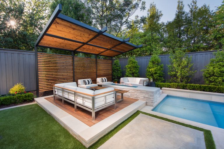 Inspiration for a mid-sized modern backyard patio kitchen remodel in Dallas with decking and an awning