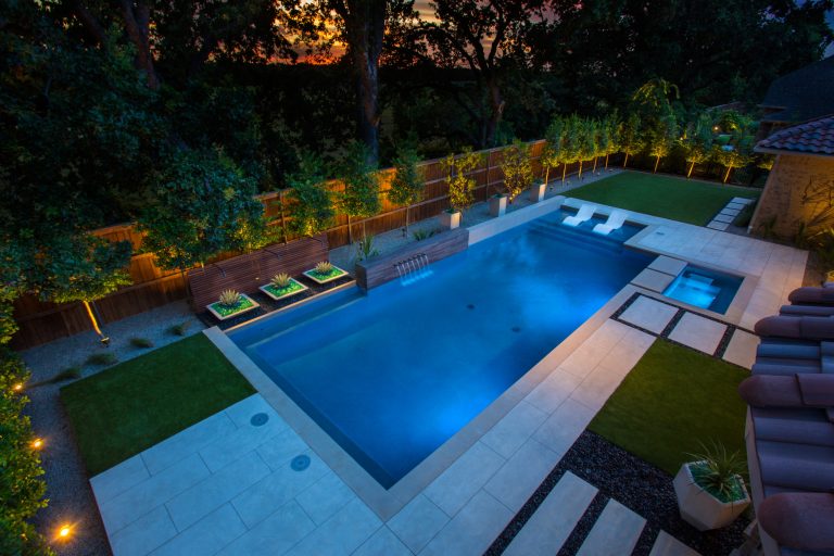 Inspiration for a mid-sized modern backyard rectangular pool fountain remodel in Dallas with decking