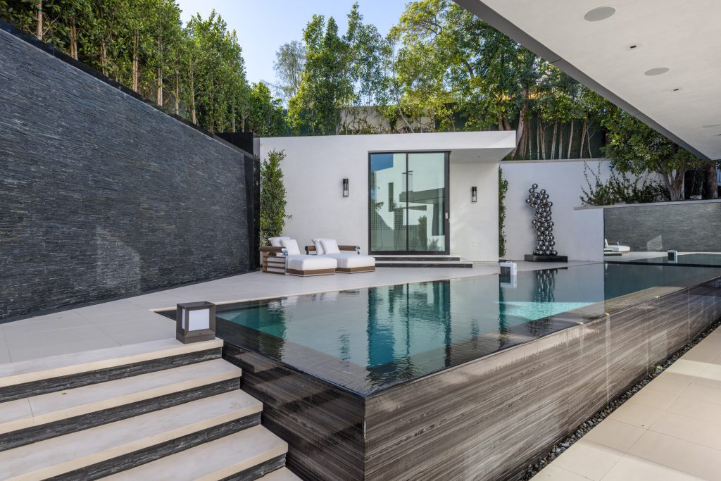 Inspiration for a mid-sized modern backyard tile and rectangular infinity pool house remodel in Orange County