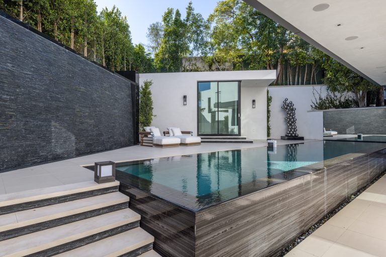 Inspiration for a mid-sized modern backyard tile and rectangular infinity pool house remodel in Orange County