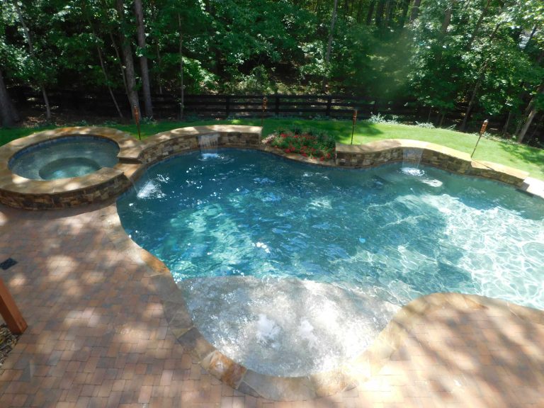 Inspiration for a mid-sized rustic backyard brick and custom-shaped natural hot tub remodel in Atlanta