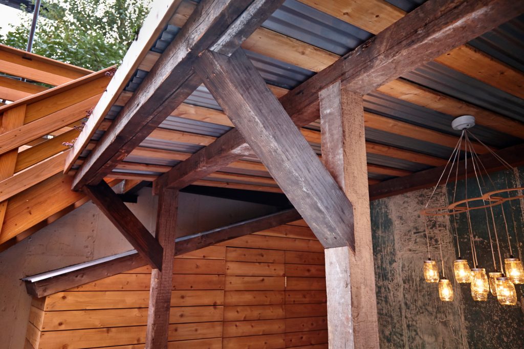 Inspiration for a mid-sized rustic backyard brick patio kitchen remodel in New York with a roof extension