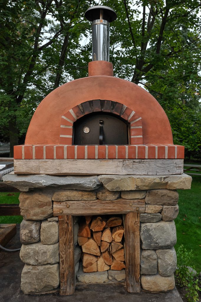 Inspiration for a mid-sized rustic backyard concrete patio kitchen remodel in New York with no cover