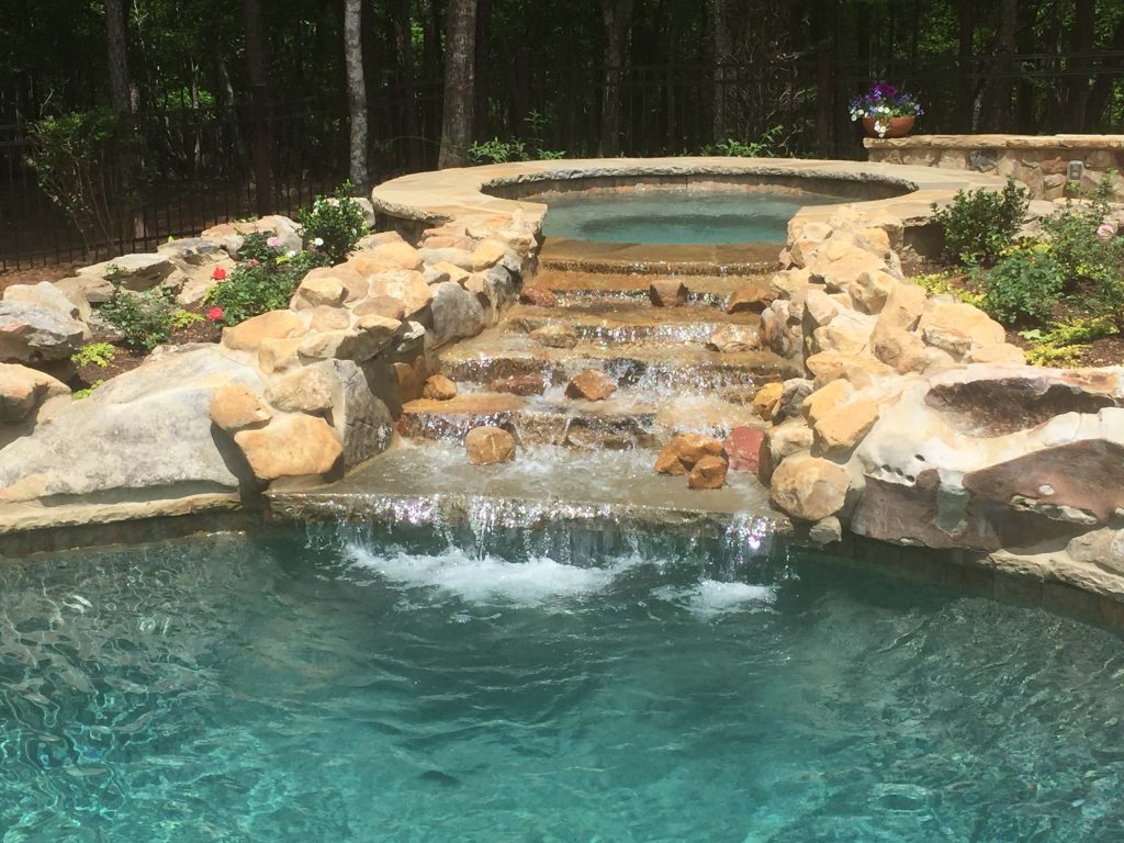 Inspiration for a mid-sized rustic backyard stone and custom-shaped natural hot tub remodel in Atlanta
