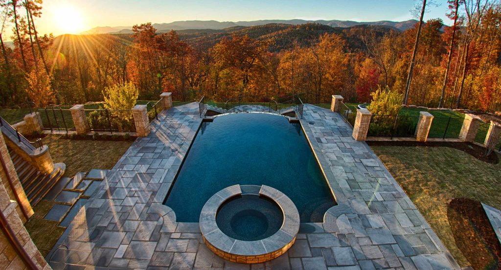 Inspiration for a mid-sized rustic backyard stone and rectangular lap hot tub remodel in Other
