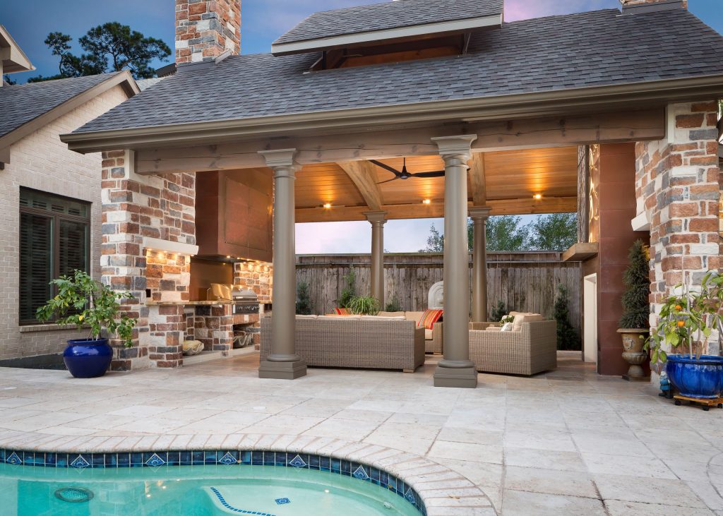 Inspiration for a mid-sized rustic backyard stone patio kitchen remodel in Houston with a roof extension
