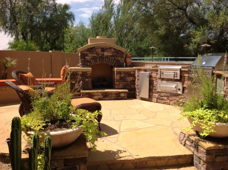 Inspiration for a mid-sized rustic backyard stone patio kitchen remodel in Phoenix with no cover