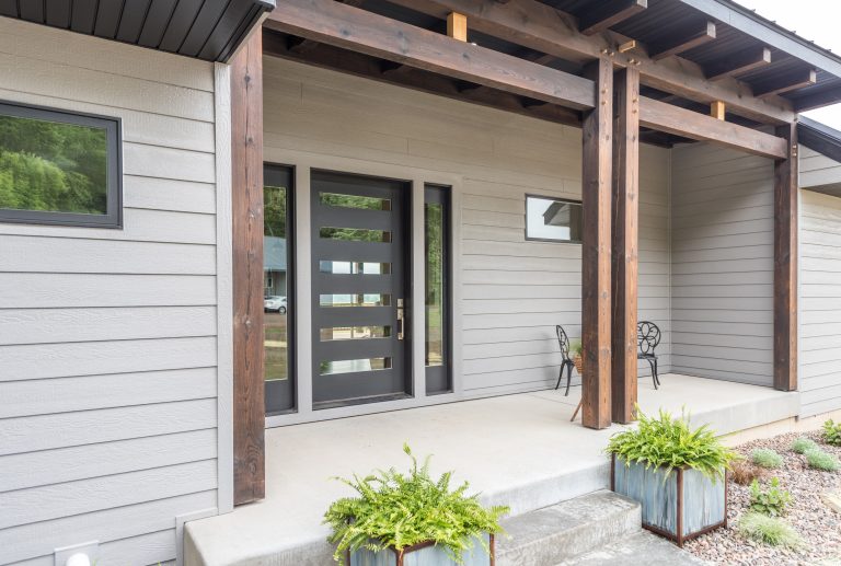 Inspiration for a mid-sized rustic concrete front porch remodel in Minneapolis with a roof extension by Lampert Lumber | Outdoor Photos | Porch | Landscaping | Landscape Design | Outdoor Living Space | Porch Design Ideas | Outdoor Living Space Ideas | Backyard Design