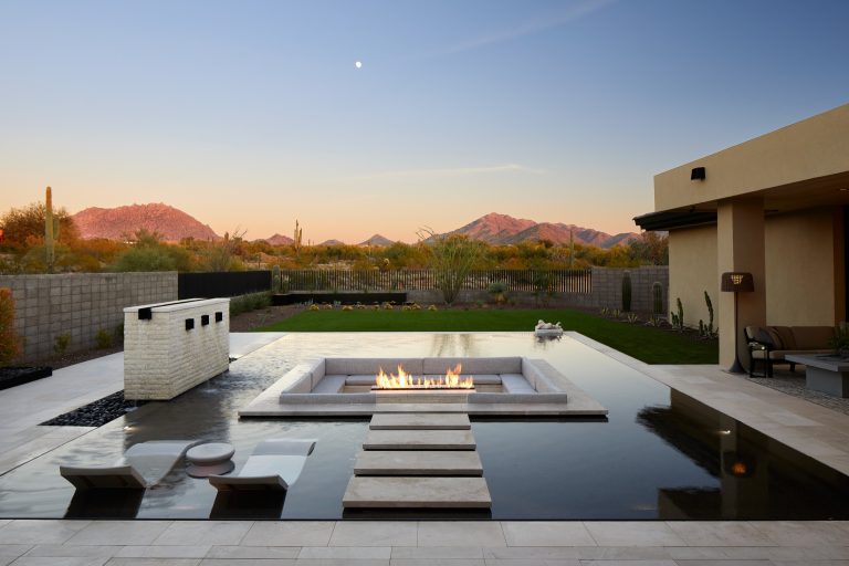 Inspiration for a mid-sized southwestern backyard tile and rectangular infinity pool fountain remodel in Phoenix